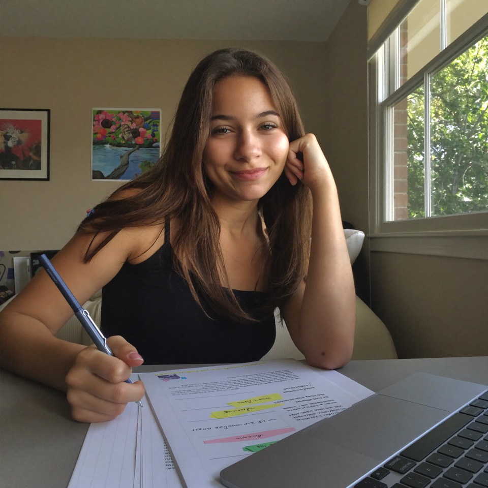 Teen girl looking confident and focused while studying with AI